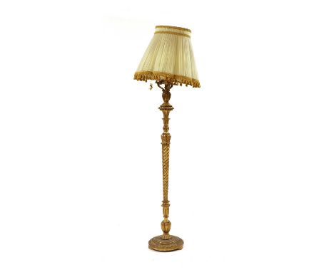A carved gilt wood standard lamp and shade, with spiral twist stem. 150cm high to top of wood.Condition report: Some wear to 