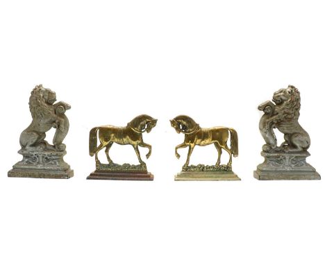 Two pairs of cast metal animal doorstops, the first brass horses on iron bases, 24cm high, the second iron lions, each stampe