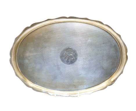 A silver tea tray, by Hasset &amp; Harper Ltd, Birmingham 1921, with engine turned decoration enclosed by a shaped border, 30