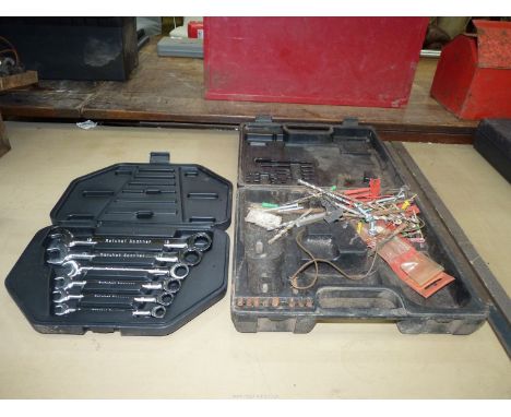 A cased six-piece metric combination Spanner set and a plastic case containing odd drill bits and fixings.