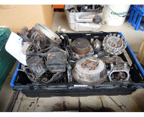 A box of mixed makes spares including a headlamp, hoses, instruments, a cylinder and piston, a five valve cylinder head, hose