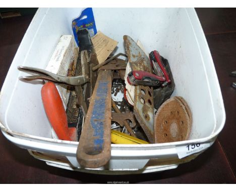 A tub of mixed tools including wire strippers, Stilsons, a surform, a multi-tool, a Vise-Grip, a plug spanner, etc.,