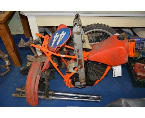 An incomplete Honda CR480 motorcycle with a two-stroke, single-cylinder, air cooled engine, newly orange powder-coated frame 