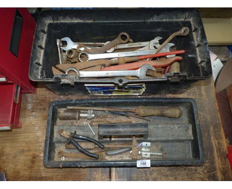 A plastic toolbox containing various combination spanners, long-reach sockets, adjustable pipe pliers, open ended spanners, a