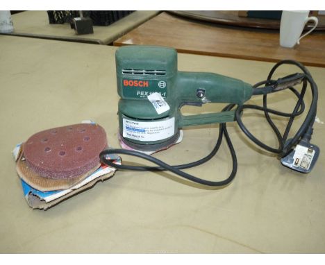 A Bosch 240 volt PEX 115A - 1, 11,000 rpm orbital sander and a good quantity of sanding discs.