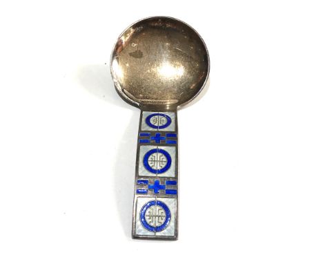 A rare sterling silver sugar or caddy spoon circa 1950 by David Andersen The round bowl passing into the wide handle which sh