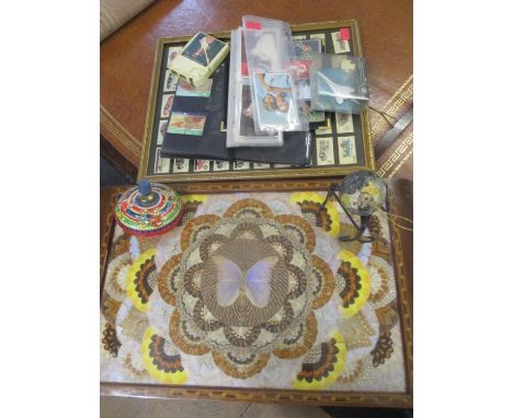 A Brazilian butterfly wing and inlaid wooden framed tray and a framed and glazed sets of cigarette cards depicting vintage ve