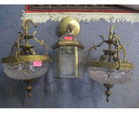 A pair of 1950s brass framed light fitting with cut glass bowls and a brass framed lantern centre light with bevelled glass 