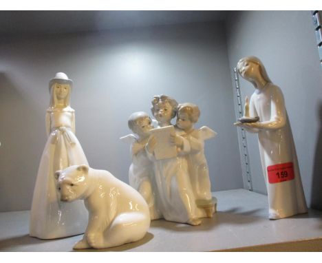 Three Lladro figures and one similar, together with a Lladro model of a polar bear cub 