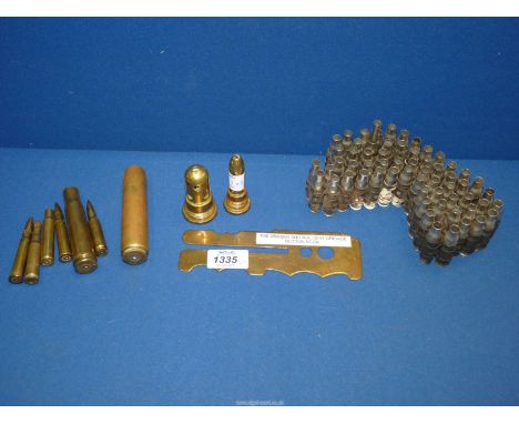 A British Army button stick along with two artillery shell primers, etc.