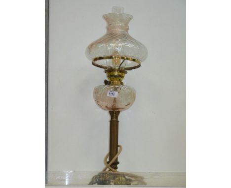 A brass based oil lamp converted to electric with pale pink glass reservoir and shade 27" tall.