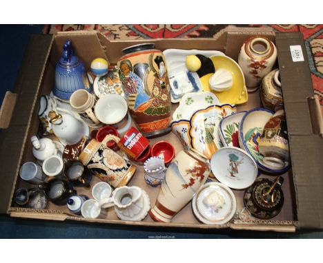 A quantity of miscellaneous china including oriental vases, Quimper wall pocket, Goebel lemon squeezer, novelty Wade Seal wit