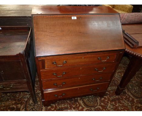 A 1940's/50's cross-banded Mahogany Bureau, the slope fall front revealing an interior with six pigeonholes, a central cupboa