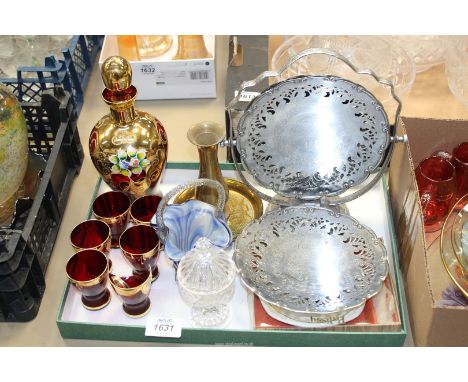 A Bohemian cranberry red decanter with five glasses, a hand blown Romanian blue glass basket, a brass vase and dish, a glass 