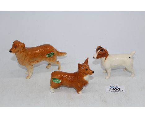 Three Beswick dogs including Corgi, Jack Russell and Retriever.
