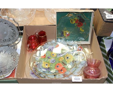 A quantity of Fiesta glass in various shapes and sizes, decorated with colourful flowers, one piece still in its box with lab