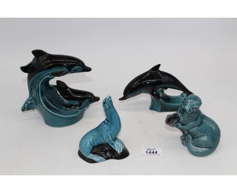 Four Poole pottery ornaments to include two seals and two dolphins.