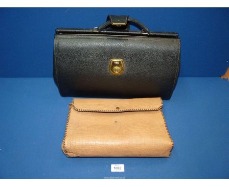A black briefcase and leather snake skin effect handbag.