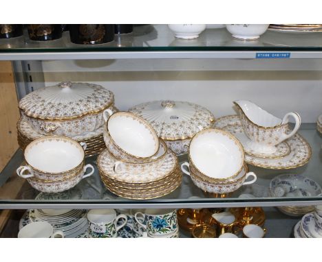 A Spode Gold Fleur De Lys part dinner service to include: six soup coups and saucers, a meat plate, sauce boat and saucers, t