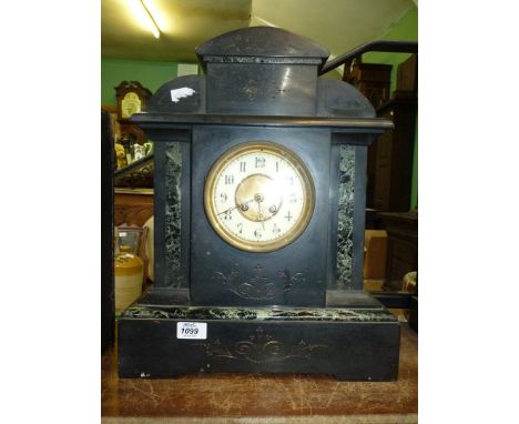 A heavy black slate Mantle Clock with green marble inlay, having Arabic numerals with pendulum, 14 1/2" wide x 18" tall.