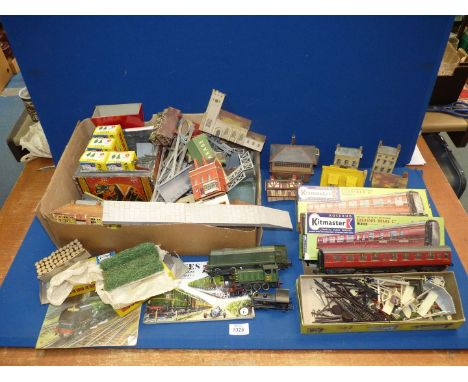 A quantity of model railway buildings and accessories to include boxed Kitmaster carriages, etc.