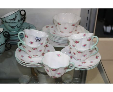 A Shelley Rosebud part tea set to include: a large plate, soups, cups and saucers, six tea plates, sugar bowl, etc.