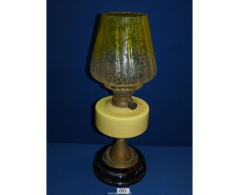 An oil lamp with opaque lemon glass reservoir and etched clear/ lemon glass shade, no chimney, base a/f 19 1/2" tall.
