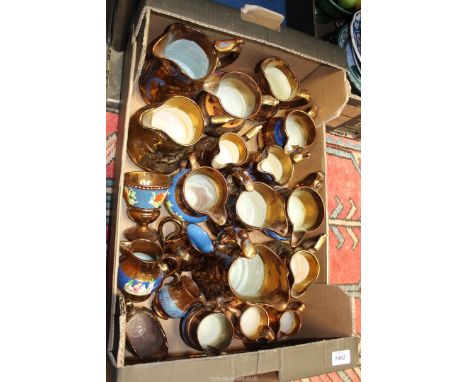 A good quantity of lustre ware jugs including Wade etc.