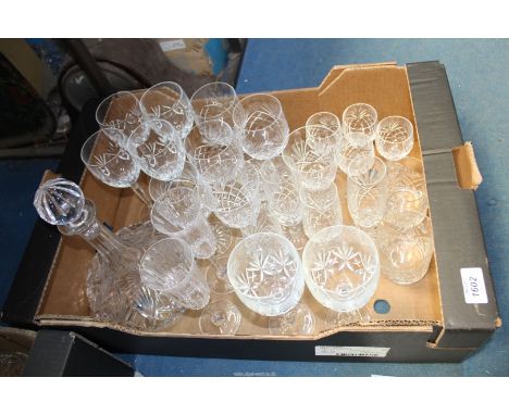 A quantity of glasses to include: wine glasses, champagne flutes, a ships decanter, etc.