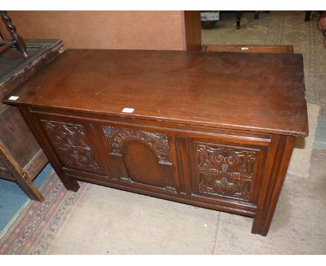 A contemporary Oak blanket Chest having three carved panels to the front, the central panel depicting an arch, 44 3/4'' wide 