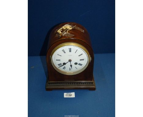 A Harrod's Ltd. London domed mahogany Mantle clock with French movement, having key and pendulum.
