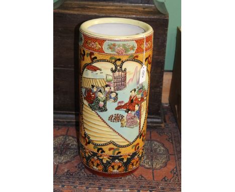 A large colourful Oriental stick stand with reserves of figures and flowers, 18" tall x 8" diameter.