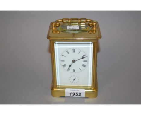 Late 19th / early 20th Century brass cased carriage clock, the enamel dial with Roman numerals and subsidiary alarm dial, the