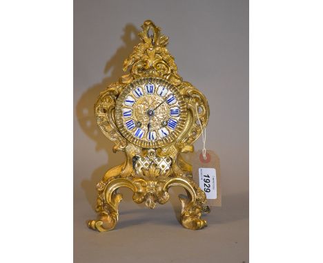 Small 19th Century French ormolu mantel clock, the cast shaped and pierced case in 18th Century style with enamel cartouche R