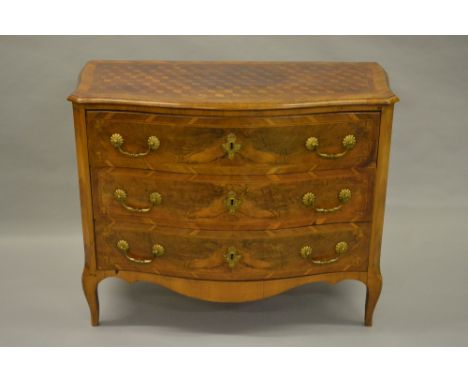 18th Century Continental walnut serpentine fronted three drawer commode, the parquetry inlaid moulded top above three drawers