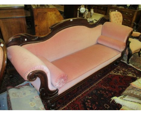 Early Victorian mahogany drawing room sofa with a shaped back and double scroll ends, above an overstuffed seat and turned su