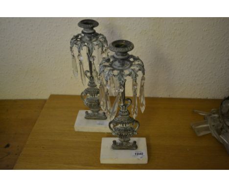 Pair of Verdigris brass candlestick lustres with cut glass drops on marble bases