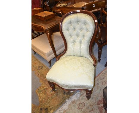Victorian button upholstered spoon back nursing chair covered in a pale green damask fabric on turned fluted front supports