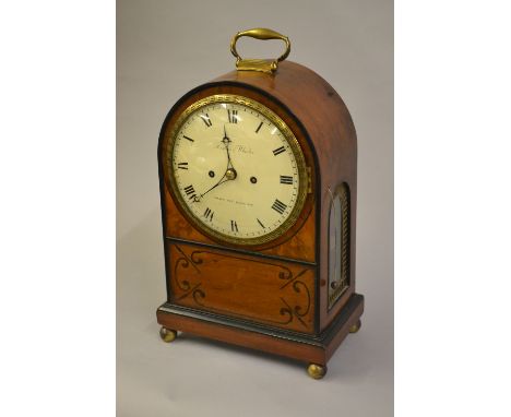 Regency mahogany black line inlaid and gilt brass mounted bracket clock, the arched case with brass carrying handle, the circ