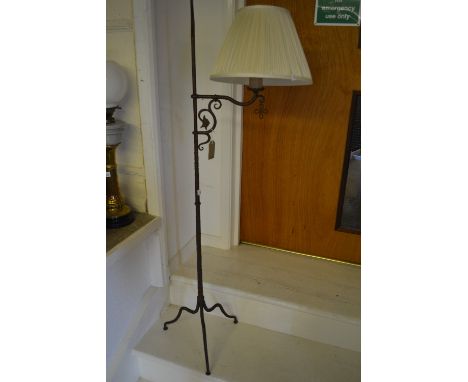 Patinated wrought iron standard lamp on tripod support