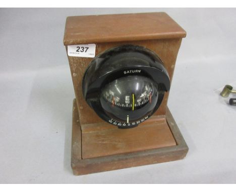 Saturn compass mounted to an oak stand