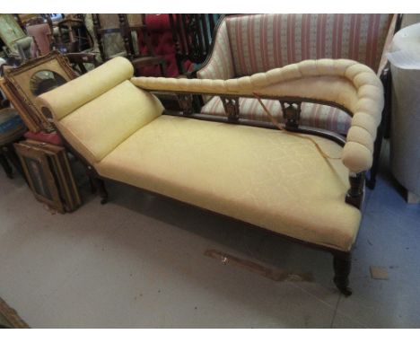 Victorian button upholstered chaise long covered in yellow fabric, on carved cabriole supports