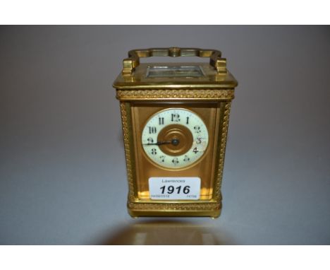 Small early 20th Century gilt brass carriage clock, the floral decorated case with enamel dial, Arabic numerals and single tr