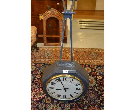 Double sided G.P.O. clock, the painted dials in an octagonal painted case with hinged metal wall bracket (modern construction