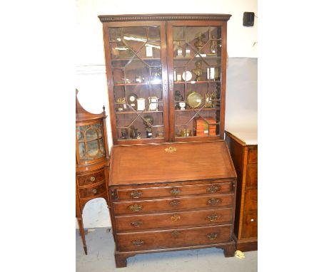 George III mahogany bureau bookcase with a moulded dentil cornice above a pair of astragal glazed doors, the base with a fall