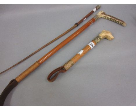 Small riding crop with carved bone dog's head whistle finial together with two other riding crops