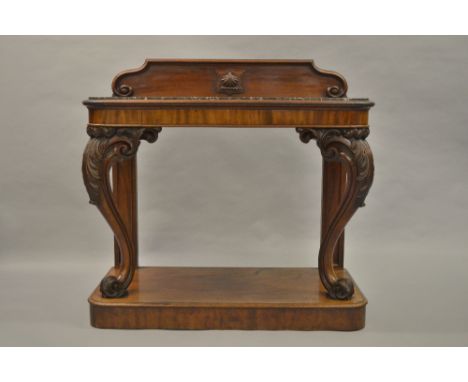 Good quality early Victorian mahogany console table, the low moulded back above a flecked marble top, plain frieze and acanth