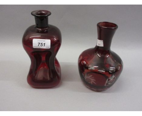 19th Century ruby glass waisted decanter together with a similar red overlay cut glass carafe