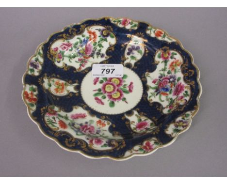 Worcester Miles Mason dish painted with panels of summer flowers on a blue scale ground, 7.5ins diameter