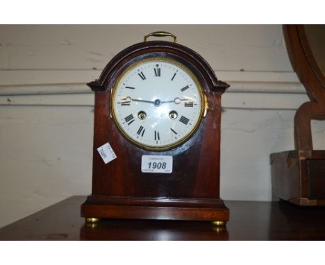 Edwardian mahogany dome shaped mantel clock, the enamel dial with Roman numerals with a two train movement striking on a gong